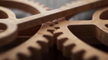 Looping animation of two wooden gears connected by a mechanical shaft. video