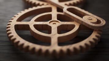 Looping animation of two wooden gears connected by a mechanical shaft. video