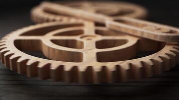 Looping animation of two wooden gears connected by a mechanical shaft. video