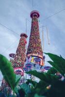 Salak yom at Wat Phra That Hariphunchai in Lamphun. The tradition of making merit, the tall dyed lott trees are decorated with different colored paper and clothing items to pay homage to the souls. photo