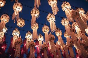 Lanterns made of colorful paper are hung during the annual festival at Wat Phra That Hariphunchai in Lamphun Province. photo