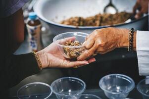 Volunteers offer free food to the poor. the concept of food sharing. photo