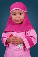 portrait of Indonesian little girl wearing hijab dress photo