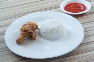 Fried Chicken with white rice and Vegetables as garnish photo