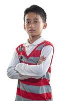 an indonesian 10 years old boy wearing red stripe sweater with confidence arm pose photo