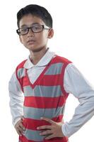 an indonesian 10 years old boy wearing red stripe sweater and glasses with confidence arm pose photo