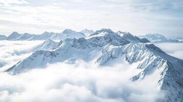 Majestic snowy mountain peak above the clouds photo