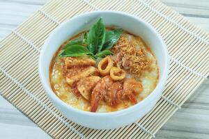 Seafood porridge consist of white rice porridge, shrimp, squid, sliced beef. photo