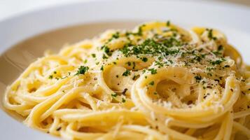 close up shot of Spaghetti Alfredo against a white backdrop photo