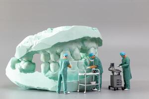 Miniature people ,A dentist displaying dental models and plaster orthodontic models photo