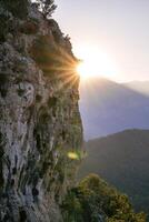 Beautiful sunset in mountains with view on a cliff and a valley on a background. Kemer, Antalya Province in Turkey. photo