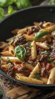 Close-up Macro Photo of Beef Penne Pasta in Tomato Sauce, Presented in a Black Pan