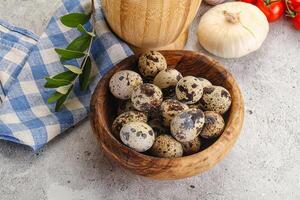 Raw quail eggs in the bowl photo