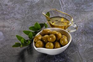 Ripe tasty green olives with branch photo