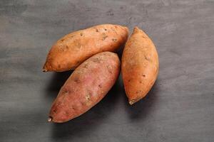 Raw ripe sweet potato heap photo