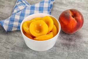 Ripe sweet and juicy canned peach photo