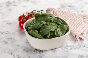 Green spinach leaves in the bowl photo