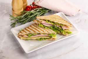 Homemade club sandwich with ham and cheese photo