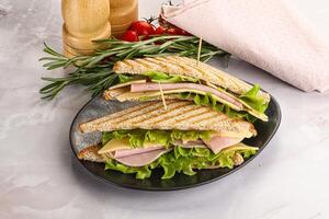 Homemade club sandwich with ham and cheese photo