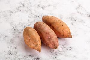 Raw ripe sweet potato heap photo