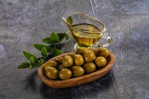 Ripe tasty green olives with branch photo