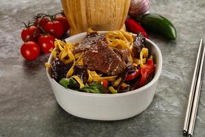 Asian wok with noodle, vegetables and beef photo