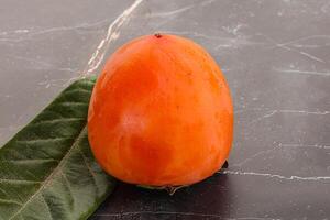 Fresh ripe sweet juicy persimmon photo