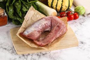 Uncooked raw pork tenderloin with spices photo