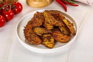 Golden baked potato Idaho with spices photo