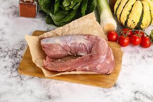 Uncooked raw pork tenderloin with spices photo