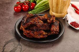 Grilled pork ribs in barbecue sauce photo