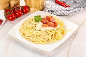 Pasta spaghetti with salmon and stracciatella photo