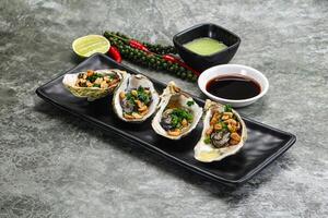 Open half oysters with green onion photo