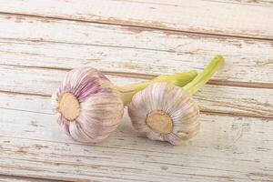 Two Young garlic over background photo