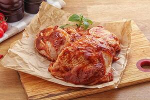 Marinated chicken leg in tomato sauce photo