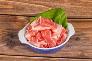 Sliced pork bacon in the bowl photo