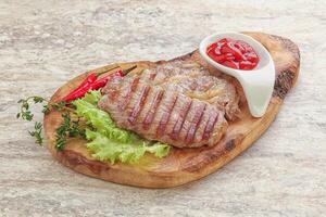 Grilled pork neck steak with ketchup photo