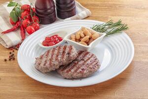 Grilled beef burger cutlet with sauce photo