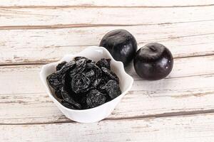 Dry prunes in thw bowl photo