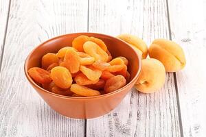 Dried apricot heap in the bowl photo