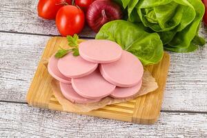 Slices boiled sausages for breakfast photo