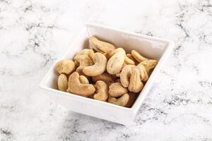 Cashew nuts heap in the bowl photo