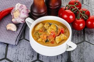 Traditional yellow Thai curry with chicken photo