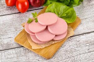 Slices boiled sausages for breakfast photo