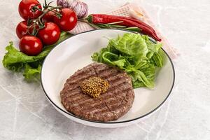 Frilled beef burger cutlet with iceberg photo