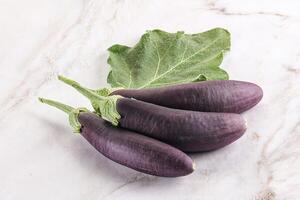 Raw ripe organic eggplant with leaf photo
