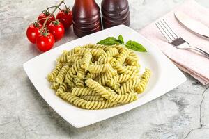 Italian pasta with basil pesto photo