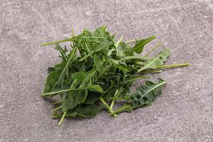 Green Arugula heap over background photo