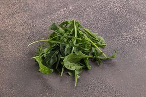 Green Arugula heap over background photo