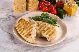 Grilled chicken breast served arugula photo